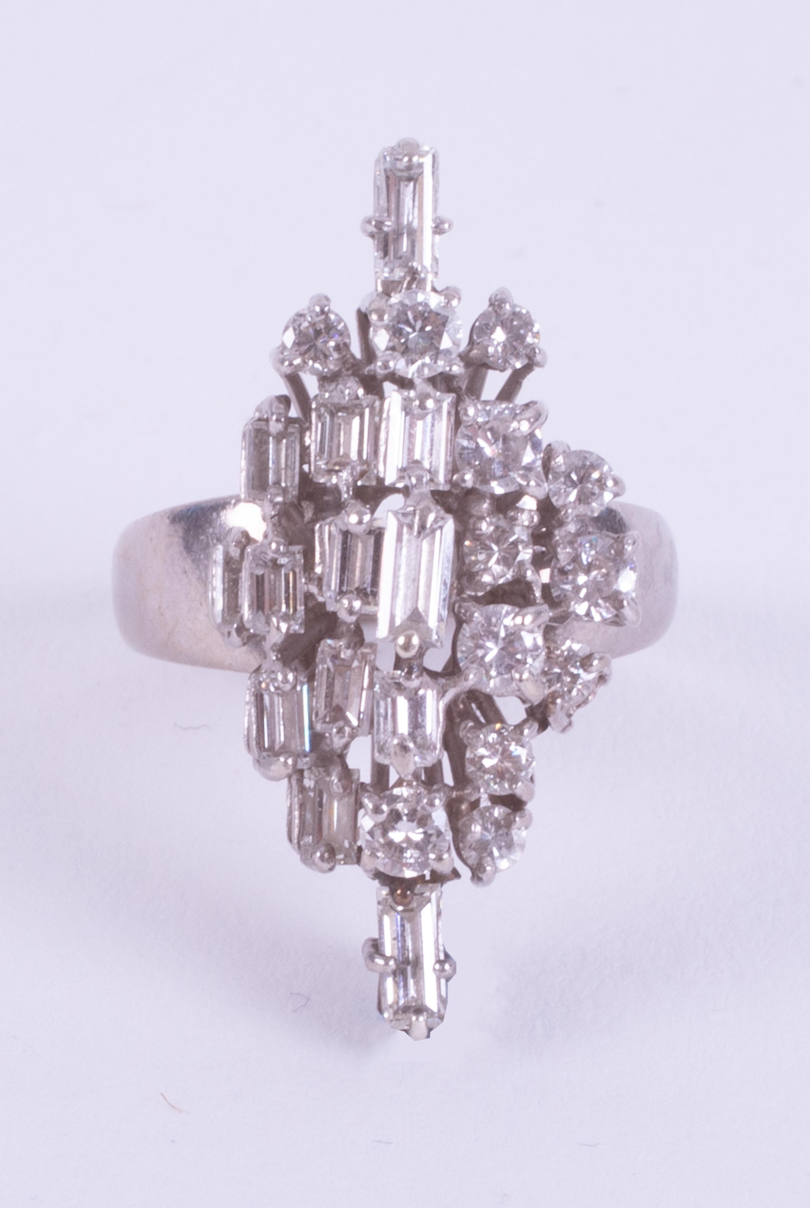 An 18ct white gold ring set with a mixture of baguette cuts and round brilliant cut diamonds in a