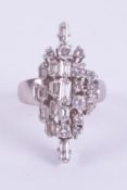 An 18ct white gold ring set with a mixture of baguette cuts and round brilliant cut diamonds in a