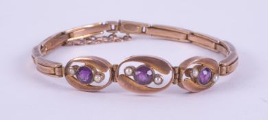 A 9ct rose gold bracelet set with round cut amethysts and seed pearls, on an articulated stretch
