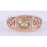 A 9ct yellow & rose gold Celtic design Clogau ring set with an oval cut peridot, measuring approx.
