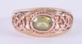 A 9ct yellow & rose gold Celtic design Clogau ring set with an oval cut peridot, measuring approx.