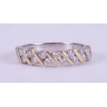 An 18ct yellow & white gold ring set with fourteen round brilliant cut diamonds, total weight