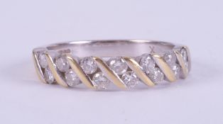 An 18ct yellow & white gold ring set with fourteen round brilliant cut diamonds, total weight