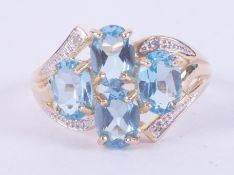 9ct yellow gold ring set with four oval cut blue topaz, total weight approx. 3.00 carats, with small