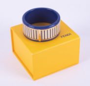 A Fendi blue acrylic bangle with wood effect striped pattern all the way around and gold tone