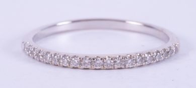 An 18ct white gold half eternity ring set with approx. 0.19 carats of round brilliant cut