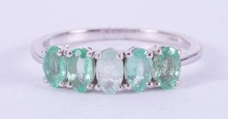 A 9ct white gold ring set with five oval cut emeralds, total weight 1.15 carats, 2.20gm, size N 1/