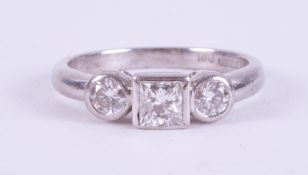 An 18ct white gold ring set with a central princess cut diamond, approx. 0.35 carats with a round