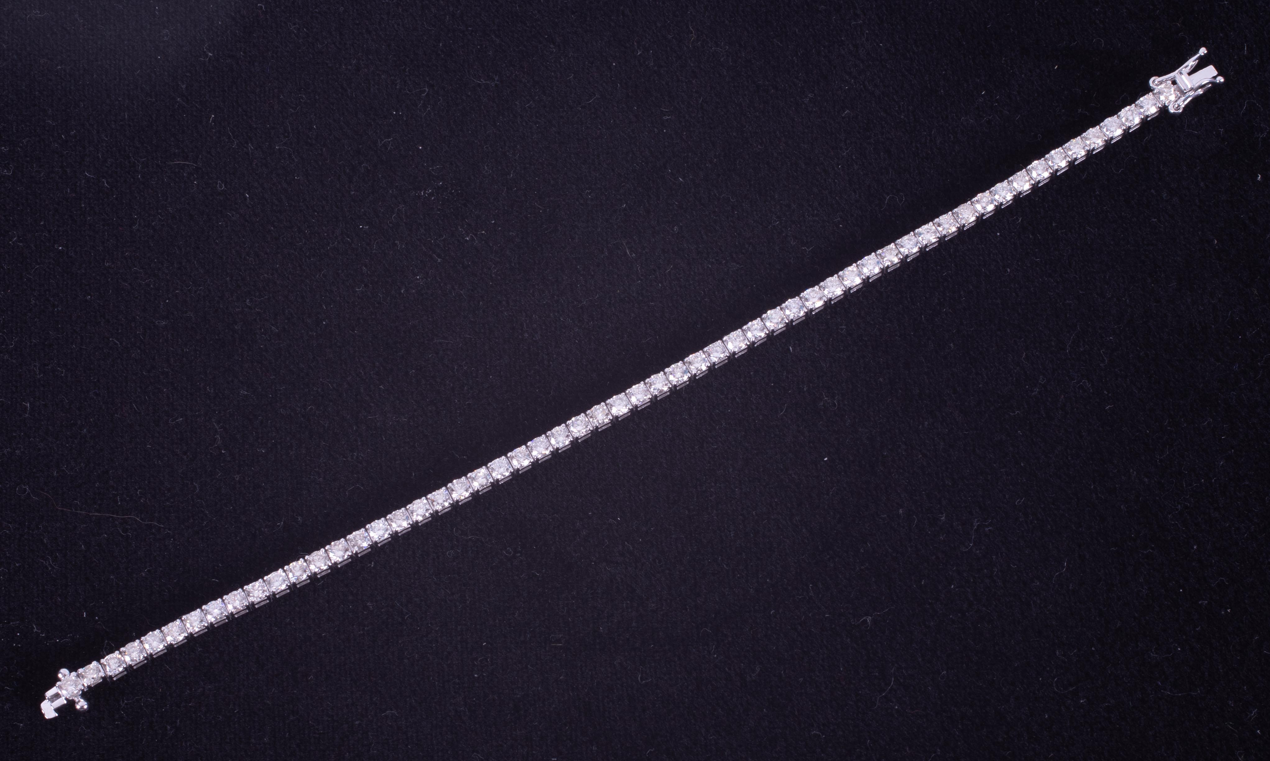 An 18ct white gold line bracelet set with approx. 5.15 carats of round brilliant cut diamonds, - Image 2 of 3