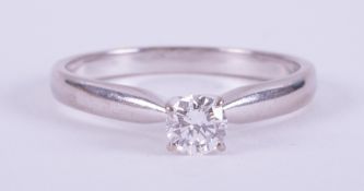 An 18ct white gold four claw ring set with a round brilliant cut diamond, 0.35 carats, colour E &