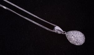 An 18ct white gold illusion setting pendant set with small round brilliant cut diamonds on an 18ct