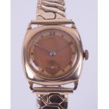 A 9ct yellow gold vintage manual wind gent's wristwatch with a cushion shaped face on a stainless