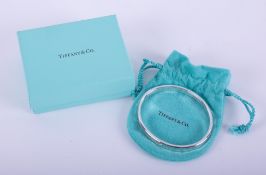 A silver Tiffany & Co oval concave design bangle, stamped inside 1997 Tiffany & Co 925 and on the