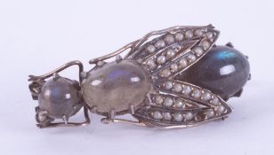 A silver? Victorian brooch in the form of a fly set with cabochon cut labradorite and tiny seed