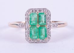 A 9ct yellow gold ring set with four baguette cut Colombian emeralds, total weight 0.58 carats