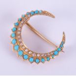 An antique yellow gold (not hallmarked or tested) crescent moon brooch set with turquoise and seed