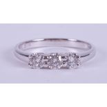 A platinum three stone ring set with round brilliant cut diamonds, total weight approx. 0.51 carats,