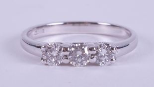 A platinum three stone ring set with round brilliant cut diamonds, total weight approx. 0.51 carats,