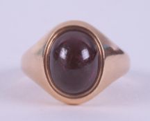 A 15ct yellow gold signet ring set with a cabochon cut rhodolite garnet, the garnet measures approx.