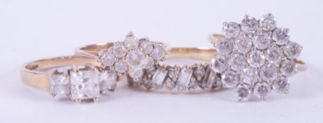 Four 9ct yellow gold rings set with cubic zirconia's/paste stones including a flower cluster style