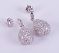 A pair of 18ct white gold drop earring with an illusion setting set with small round brilliant cut