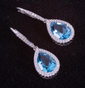 A pair of 18ct white gold drop earrings set with pear shaped blue topaz, total weight approx. 3.34