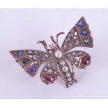 A Victorian rose gold (not hallmarked or tested) butterfly brooch/pendant set with sapphires,
