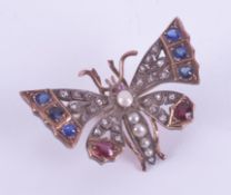 A Victorian rose gold (not hallmarked or tested) butterfly brooch/pendant set with sapphires,