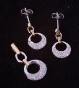 An 18ct yellow & white gold set comprising of a pair of circle design earrings set with small
