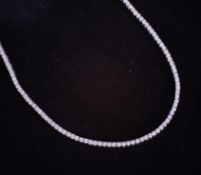 A fine 18ct white gold line necklace set with approx. 8.00 carats of round brilliant cut diamonds,