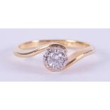 An 18ct yellow & white gold twist design ring set with 0.15 carats of round brilliant cut diamond,