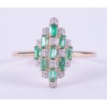 A 9ct yellow gold marquise shaped ring set with 0.39 carats of baguette cut Colombian emeralds