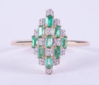 A 9ct yellow gold marquise shaped ring set with 0.39 carats of baguette cut Colombian emeralds