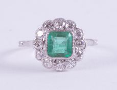 A fine platinum ring (not hallmarked or tested), set centrally with a square cut emerald, approx.