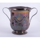 An early 19th Century silver twin handled cup with embossed decoration of swags with a turret and