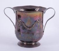 An early 19th Century silver twin handled cup with embossed decoration of swags with a turret and