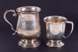 A silver baluster shaped christening mug with scroll handle, height 7cm, together with a small