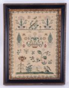 An 18th/19th century sampler decorated in stylised flowers, birds and motifs, not signed, 32cm x