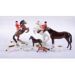 A Beswick hunting group together with two Royal Doulton horses (some damage to the hunting group).