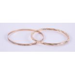 Two 9ct yellow gold bangles, one with engraved pattern & one twist design, 7.34gm.