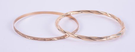 Two 9ct yellow gold bangles, one with engraved pattern & one twist design, 7.34gm.