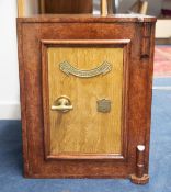 A vintage safe which has been overpainted and decorated in faux wood effect, with plaque '