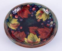 William Moorcroft, a Flambe leaf and berries design plate, diameter 22cm.