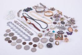 A collection of costume jewellery to include cameos, beads, some silver items, brooches, watches,