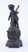 A 19th century bronze statue, a cherub carrying a staff (a/f) stood upon a pedestal with a