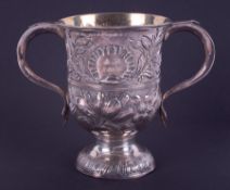 A Georgian silver twin handled cup with embossed decorated with flowers, London hallmark, letter H