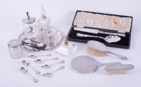 A three piece silver back dressing table set, six silver teaspoons with St Magnus Cathedral scene,