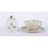 A Belleek cup and saucer together with a Belleek honeypot No0357 (damage).