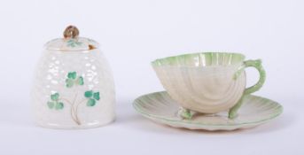 A Belleek cup and saucer together with a Belleek honeypot No0357 (damage).