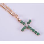 A 9ct yellow gold 18" figaro style chain with a 9ct yellow gold emerald & diamond set cross, 4.